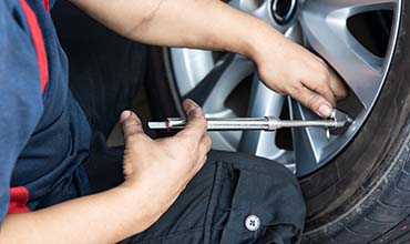 image of mechanic checking tire pressure monitoring