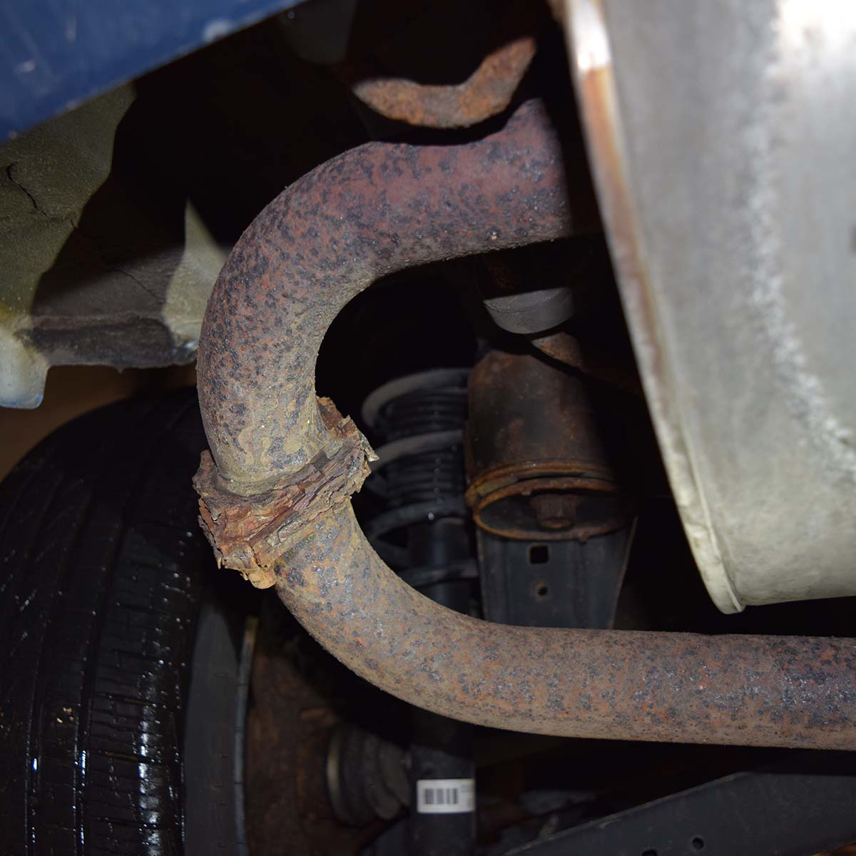 Image of rusty exhaust pipe and muffler